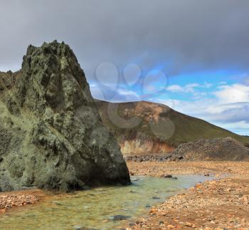 Green stone cliff and creek in the gorge. National Park Landmannalaugar in Iceland