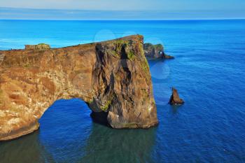  Colossal rock- elephant lit sunset. Cape Dirholaey in southern Iceland in July.