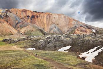 The famous Valley Landmannalaugar in Iceland. Multicolored rhyolite mountains with the remnants of last year's snow in July