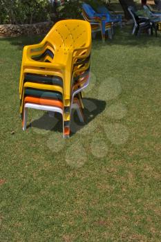  Bright multi-coloured chairs on a lawn near pool