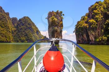 The holiday in Thailand. Bay in the Andaman Sea and exotic island. A boat trip with a red lantern