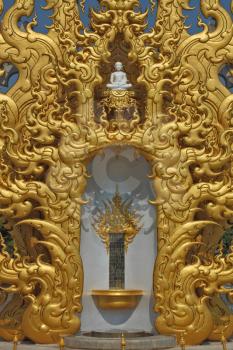 Separate chapel with statues of the Buddha. The chapel is overgilded and decorated in style of new Thai architecture