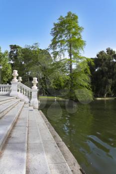 White marble steps and lake in park Buen-Retiro in fine May day
