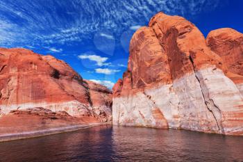  Lake Powell is surrounded by magnificent red hills. Walk on the boat at sunset. Scenic huge artificial water basin of the Colorado River, USA