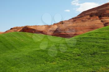 Hills from red sandstone and green grassy hills for a golf