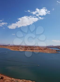 . Superb huge and beautiful Lake Powell. Motorboats cut the smooth water of the lake