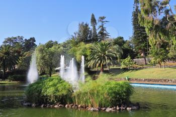 A wonderful sunny day in the park. Picturesque lake with islands and fountains