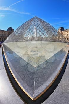 Paris, September 8: The world-famous entrance to the Louvre - the glass pyramid and a spectacular fountain of September 8, 2012 in Paris. Picture taken Fisheye lens