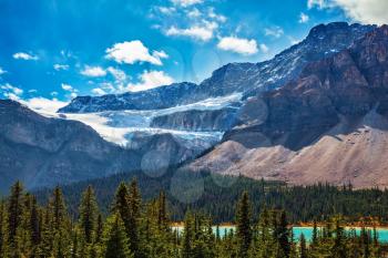 Canada, Rocky Mountains, Alberta, Banff National Park. The Glacier Crowfoot over Bow River  in an environment of bright striped mountains