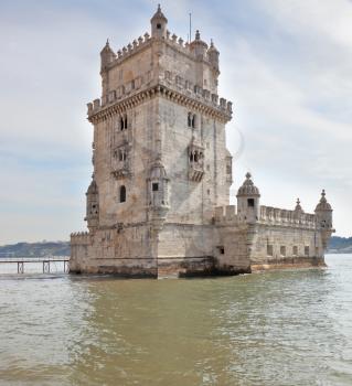 The famous Tower of Belem in the water of the river Tagus. White marble tower is decorated with turrets and battlements in the Moorish style. Portugal, Lisbon