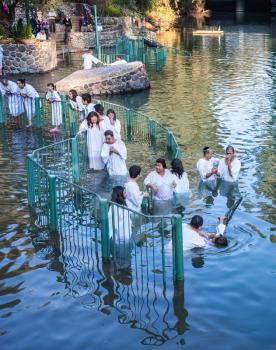 YARDENIT, ISRAEL - JANUARY 21, 2012: Christian pilgrims enter Jordan River waters. They make  baptism ceremony in honor of Jesus Christ's baptism here