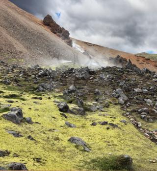 Rhyolite mountains smoldering underground heat. In the hollows lie unmelted snow patches from last year. Iceland in July
