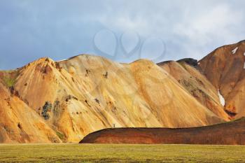  Snow remained on the mountains since last year. Pink and orange Mountains National Park Landmannalaugar in Iceland