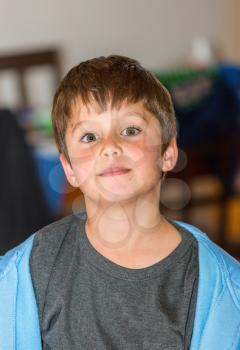 Thoughtful handsome boy posing on the child family party