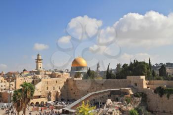 The Western Wall of the Temple and the Mosque of Omar.  The golden dome shines in the morning sun