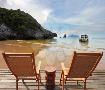 Charming lookout for two. Two convenient comfortable guest sun loungers and a bedside table are worth on a wooden platform. Hence it is convenient to admire the sandy sea beach