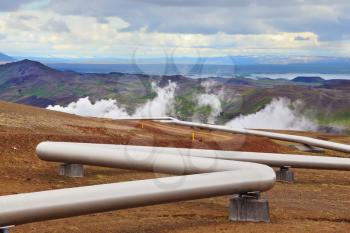  Pipeline to transport hot water. Summer Iceland. Krafla Lake neighborhood. Steam rises above the hot ground