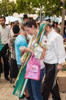 JERUSALEM, ISRAEL - OCTOBER 8, 2014: Religious Jews are buying products for the holiday. Sukkot in Israel. Traditional holiday market in Jerusalem