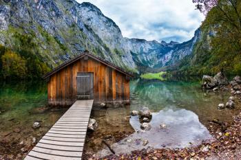 Enchanted Lake Obersee in the Bavarian Alps. Boat garage in the middle of the lake. The concept of active tourism and ecotourism