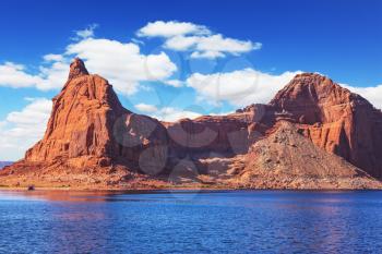  Lake Powell is surrounded by magnificent sandstone hills. Boat trip on sunny day. Scenic huge artificial water basin of the Colorado River, USA