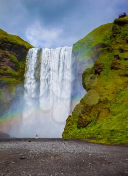 Magnificent powerful jet Skógar River forms a large rainbow. The famous waterfall Skógafoss, Iceland