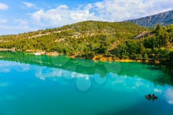 Spring Provence. Azure water mirror reflecting clouds. The biggest mountain canyon in the French Alps - Verdon