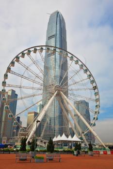 HONG KONG, DECEMBER 11, 2014:  Hong Kong Special Administrative Region. The modern city on the ocean coast. Ferris wheel and skyscraper 