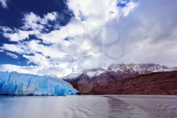Chilean Patagonia. National Park Torres del Paine. Lake and Glacier Grey. The clouds covered the sun cold. Grey glacier moves down the water of the lake