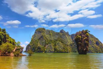 Calm bay and bizarre island. James Bond Island. The tourist season in Thailand