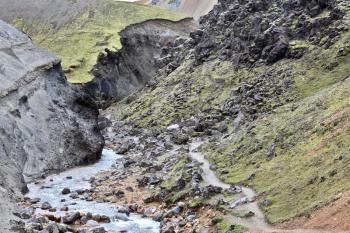  Creek at the bottom of a picturesque gorge and the path down the mountainside. National Park Landmannalaugar in Iceland