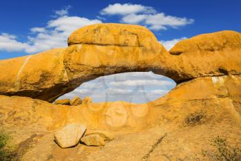 Natural array of bald granite outcrops among the Namib Desert. Stone arch Spitzkoppe, Namibia. The concept of extreme and ecological tourism