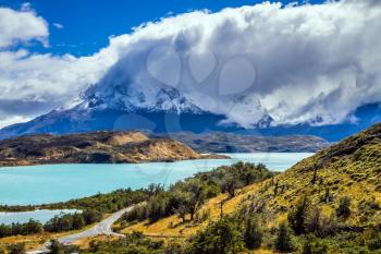 The magnificent cliffs of Los Cuernos are covered with snow. Torres del Paine National Park. Summer in the south of Chile. The concept of extreme and active tourism