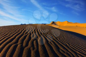 The contrast of light and shadow on the waves of sand in the morning at sunrise. Sand dunes in Death Valley, USA