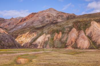 Pink and green rhyolite mountains surround the valley.  Summer morning in the National Park Landmannalaugar, Iceland