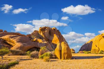 The massive granite outcrops in the Namib Desert. Picturesque morning light on the rocks. Stone of Spitzkoppe, Namibia. Concept of extreme and ecological tourism