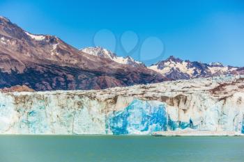 Massive glacier descends into the water.  The picturesque  shore of Lake Viedma. In the water ice-floes, broken away from a glacier