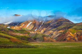 National Park Landmannalaugar, Iceland. Pink dawn in the Arctic. Striped mountains of rhyolite covered sunrise