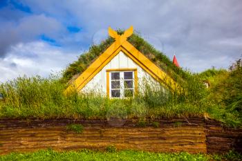  Interesting ethnographic museum Glaumbaer in Iceland. Facade of the farmhouse and outbuildings, covered with grass. The concept of the historical and cultural tourism