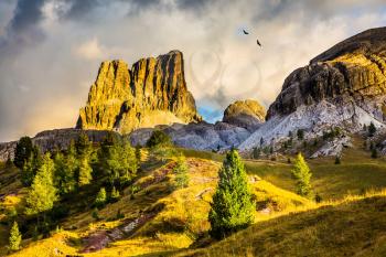 Last sunny day of fall. Concept of active and extreme tourism. Travel in the Dolomites. To pass Faltsarego approaching snowstorm