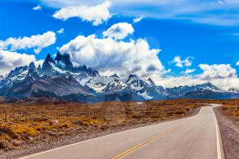 Summer day in Argentine Patagonia. Fine highway to the majestic Mount Fitz Roy. The concept of active and extreme tourism