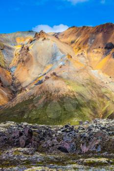  Travel to Iceland in the July. Summer volcanic tundra. Incredible shades of rhyolitic mountains - yellow, orange, green and blue