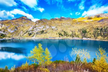 The concept of ecological tourism. The harmony of the Dolomites. Mountain Lake Lago di Fedaia, Dolomites. Glacial lake with clear cold water