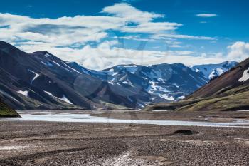 Rhyolite mountains surround the flat valley Park Landmannalaugar. Valley cross streams and rivers of meltwater