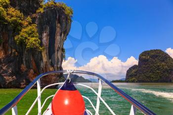 A boat trip with a red lantern. The holiday in Thailand. Bay in the Andaman Sea and exotic island 