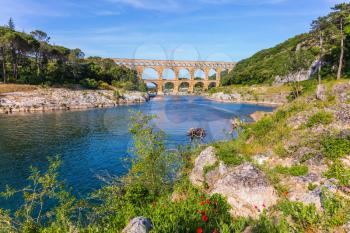 Three-tiered aqueduct Pont du Gard - the highest in Europe.  Provence, spring sunny day. The bridge was built in Roman times on the river Gardon