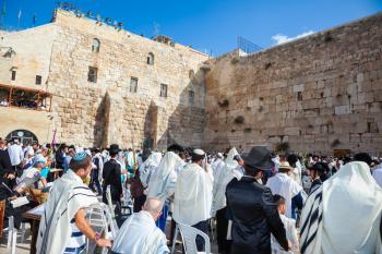 JERUSALEM, ISRAEL - OCTOBER 12, 2014:  Morning autumn Sukkot, Blessing of the Kohanim. The Jews of tallit hold four ritual plants. The area in front of Western Wall of Temple filled with people