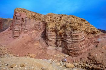 Dry stone desert near the southern seaside resort of Eilat, Israel. Pink sandstone buttes of bizarre shapes