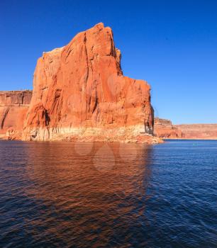 Scenic huge artificial water basin of the Colorado River, USA. Lake Powell is surrounded by magnificent sandstone hills. Walk on the boat at sunset