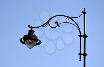 Street black iron lamp on blue sky