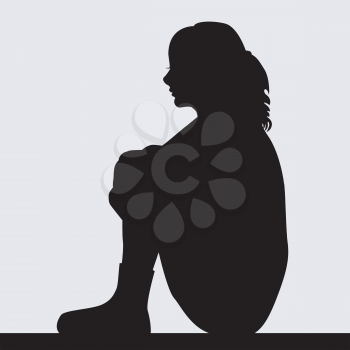 Silhouette of sad young woman